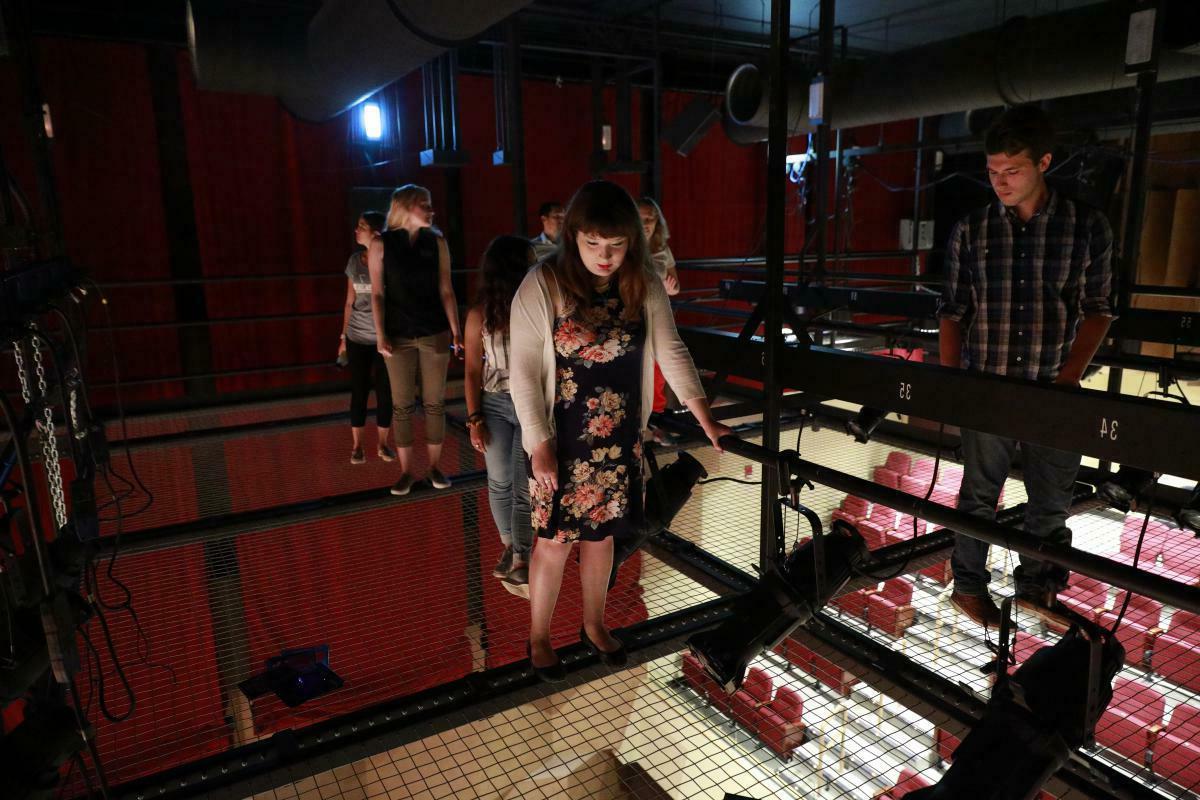 Students standing on a theatre catwalk